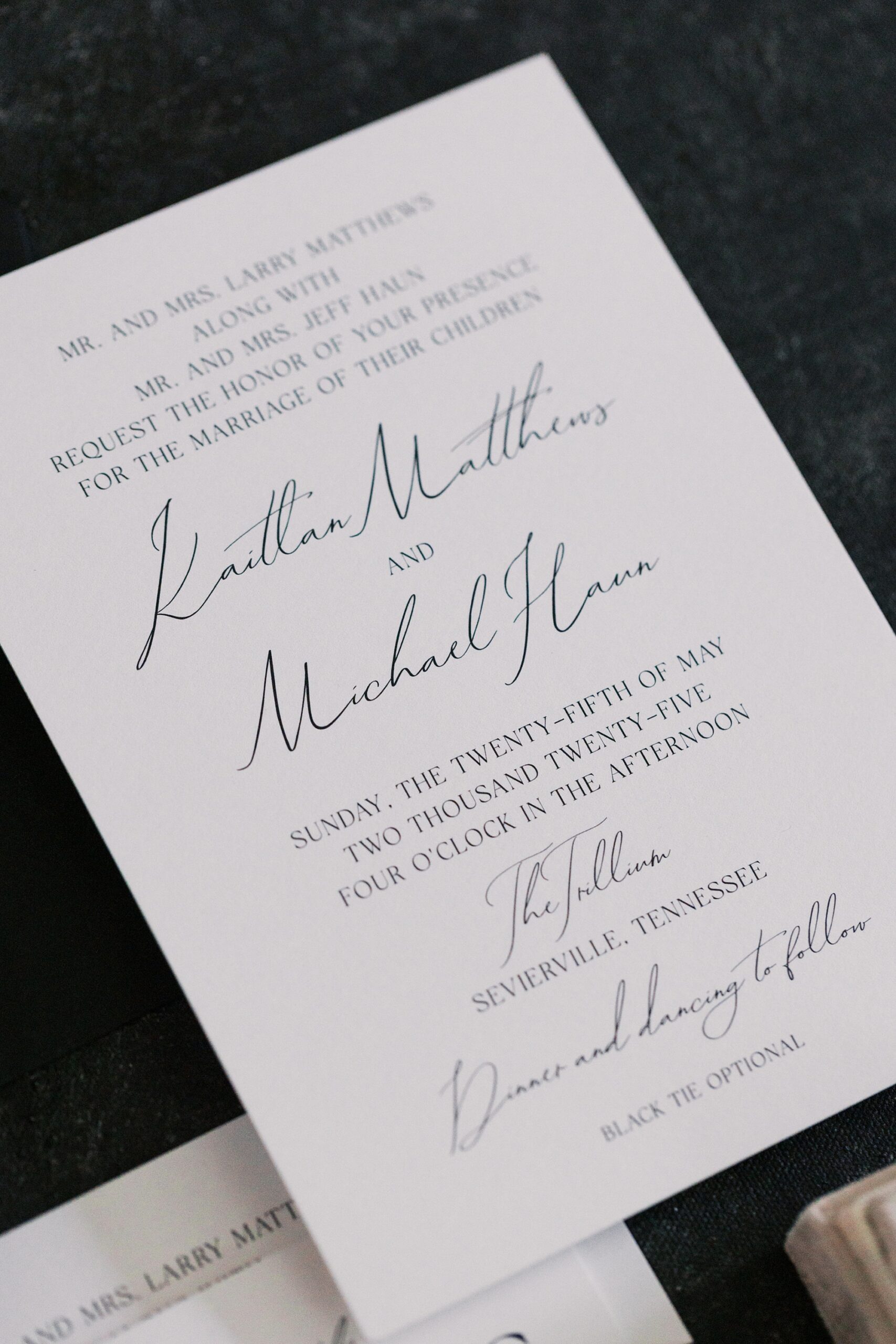 crisp white invitation with elegant black lettering