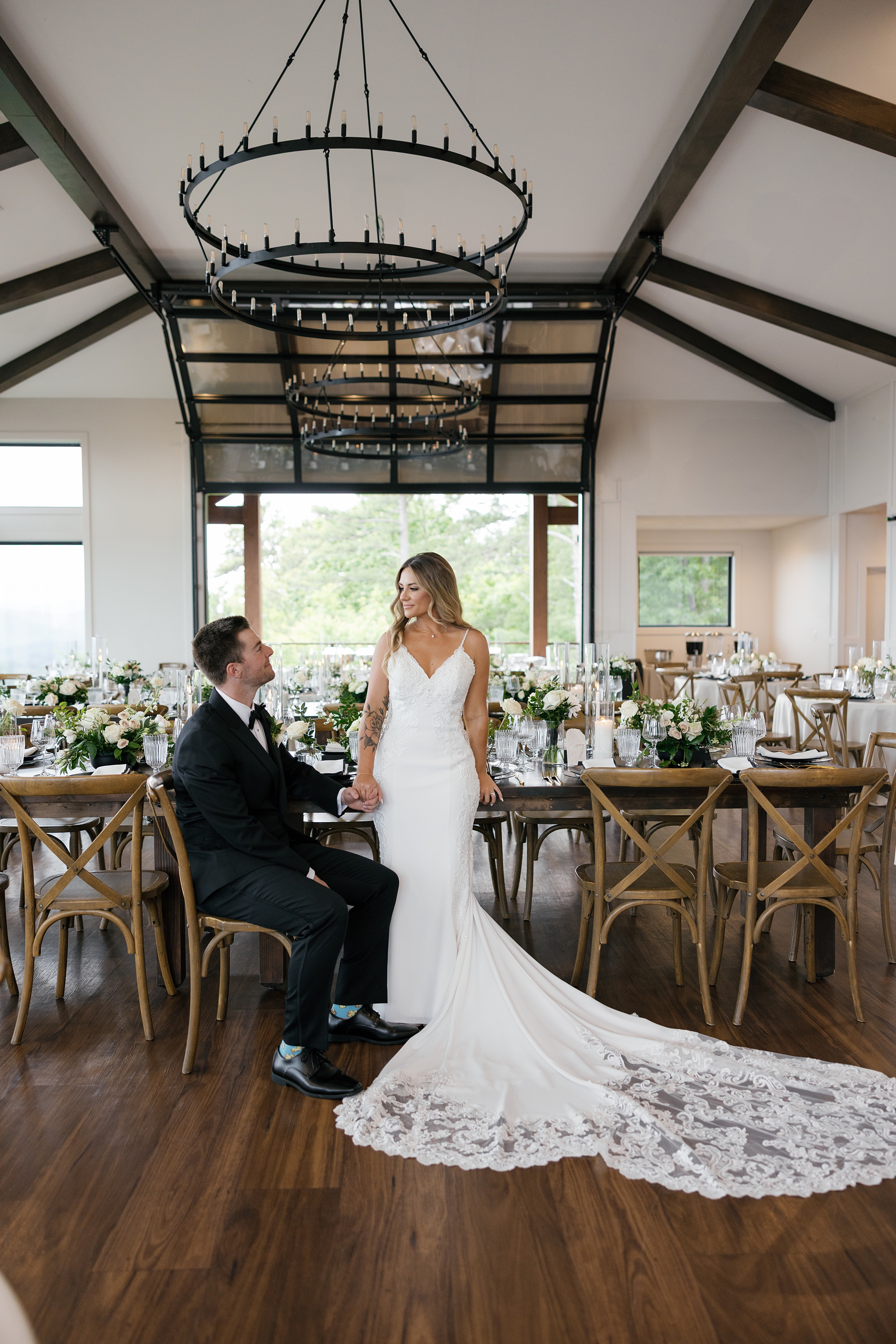 bride and groom sit inside elegant reception at The Trillium in East Tennessee