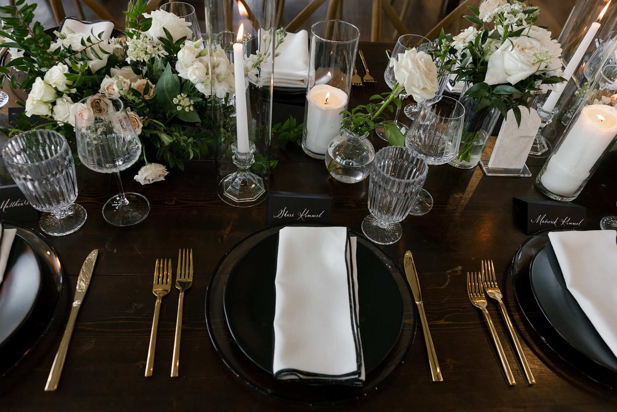 Timeless black and white wedding details on tablecape with black place card featuring white calligraphy 