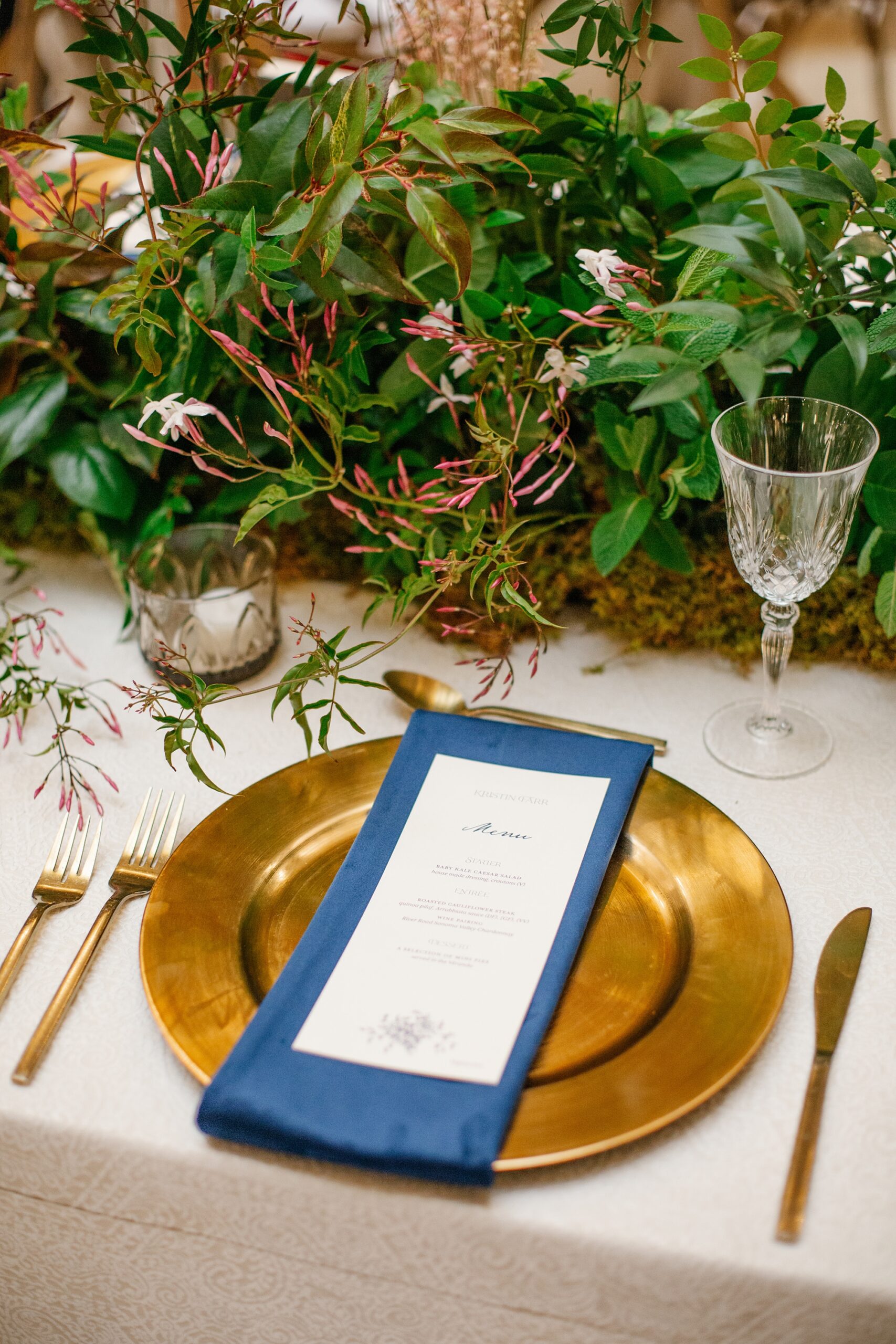wedding menus on navy napkins and gold plates 