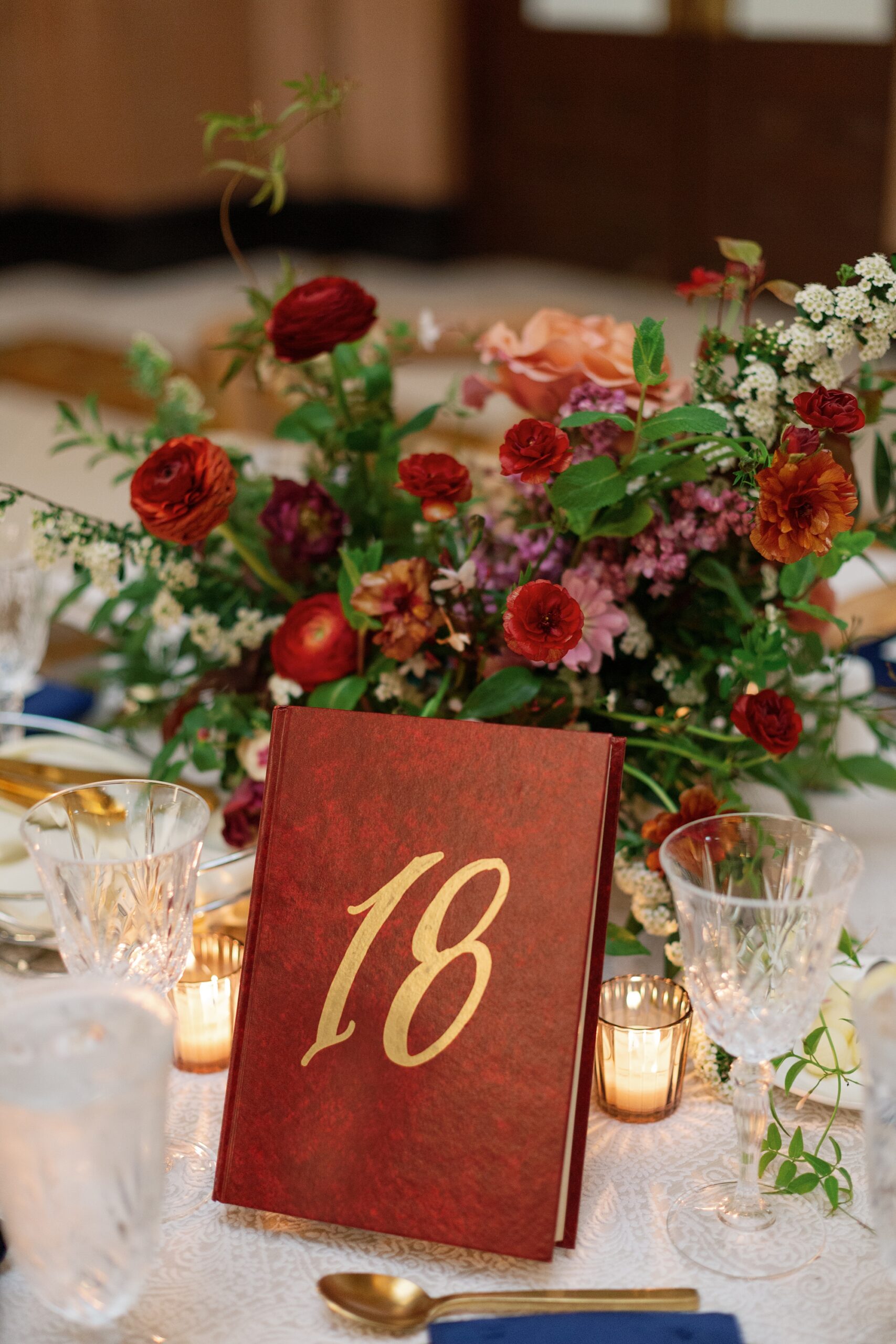 dark red book with gold number 18 hand-painted on it for table number 