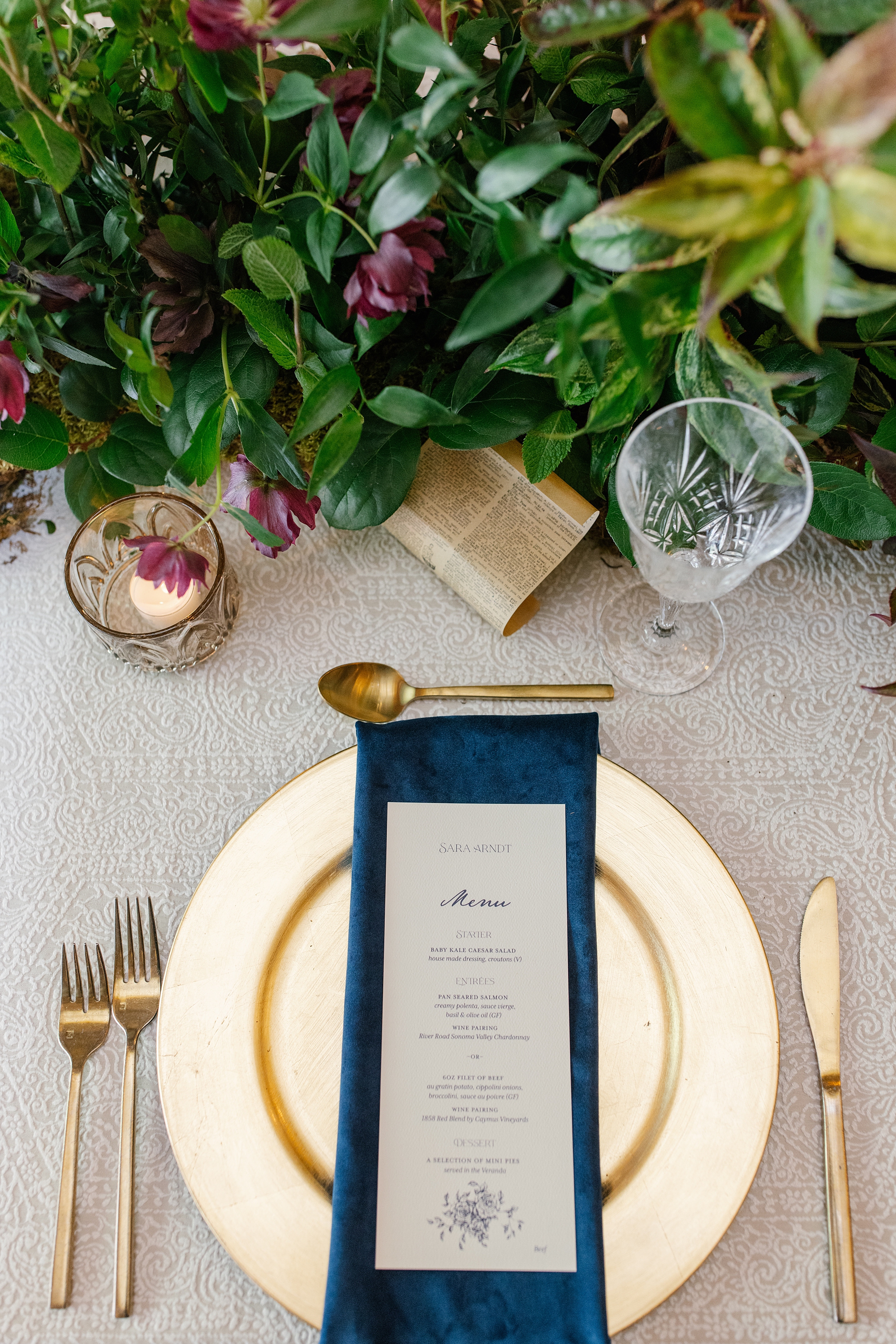 wedding menus on navy napkins on gold plates 