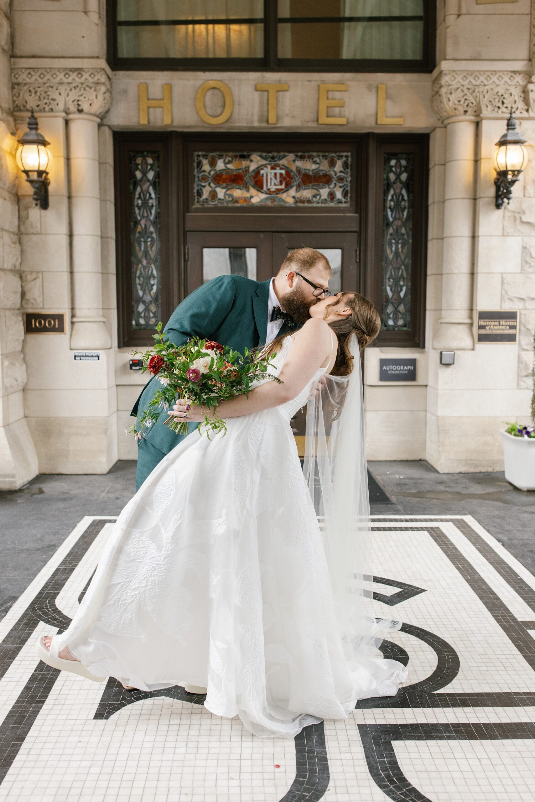 newlyweds kiss outside of Union Station Hotel in Nashville