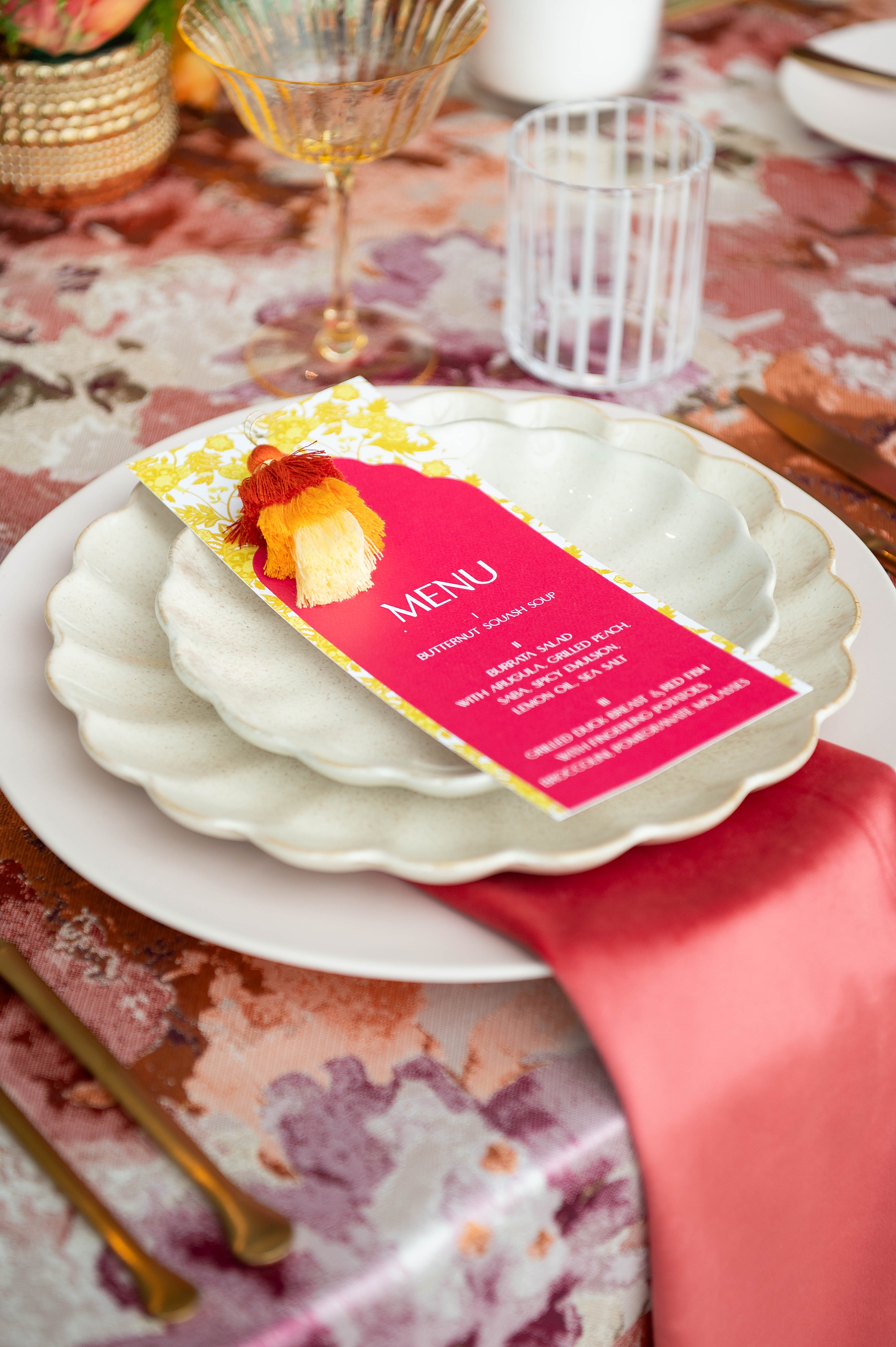 pink and yellow menus featuring ombre pom pom attached to the top