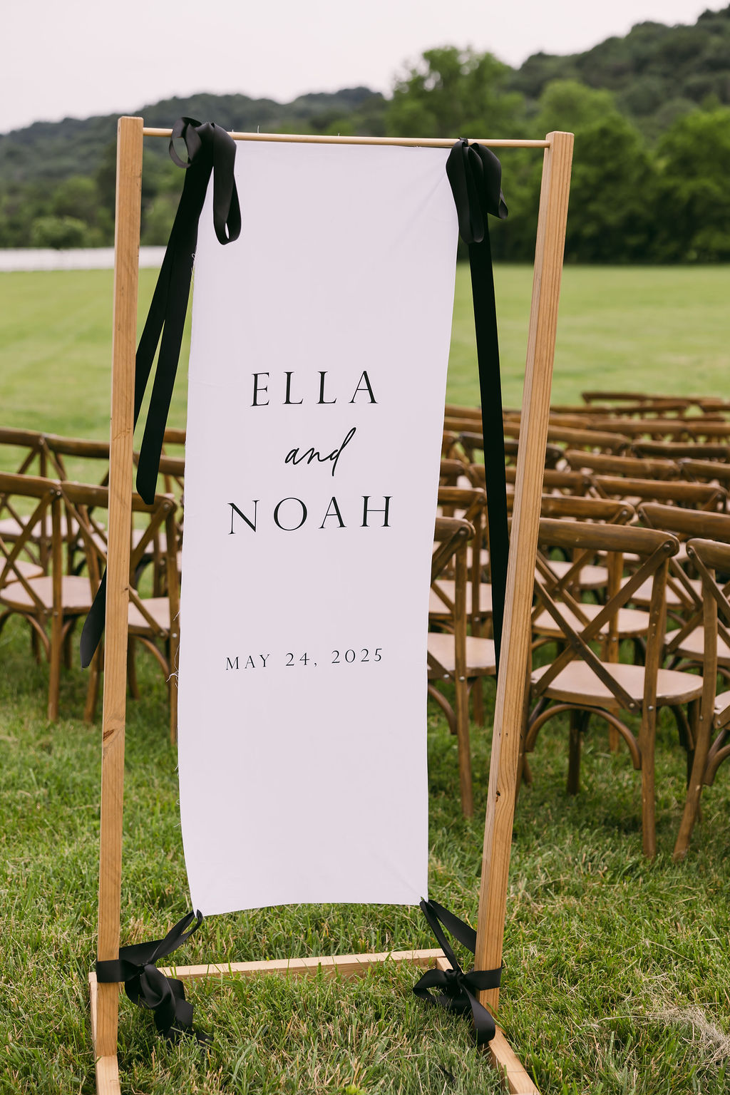 white fabric wedding ceremony welcome sign