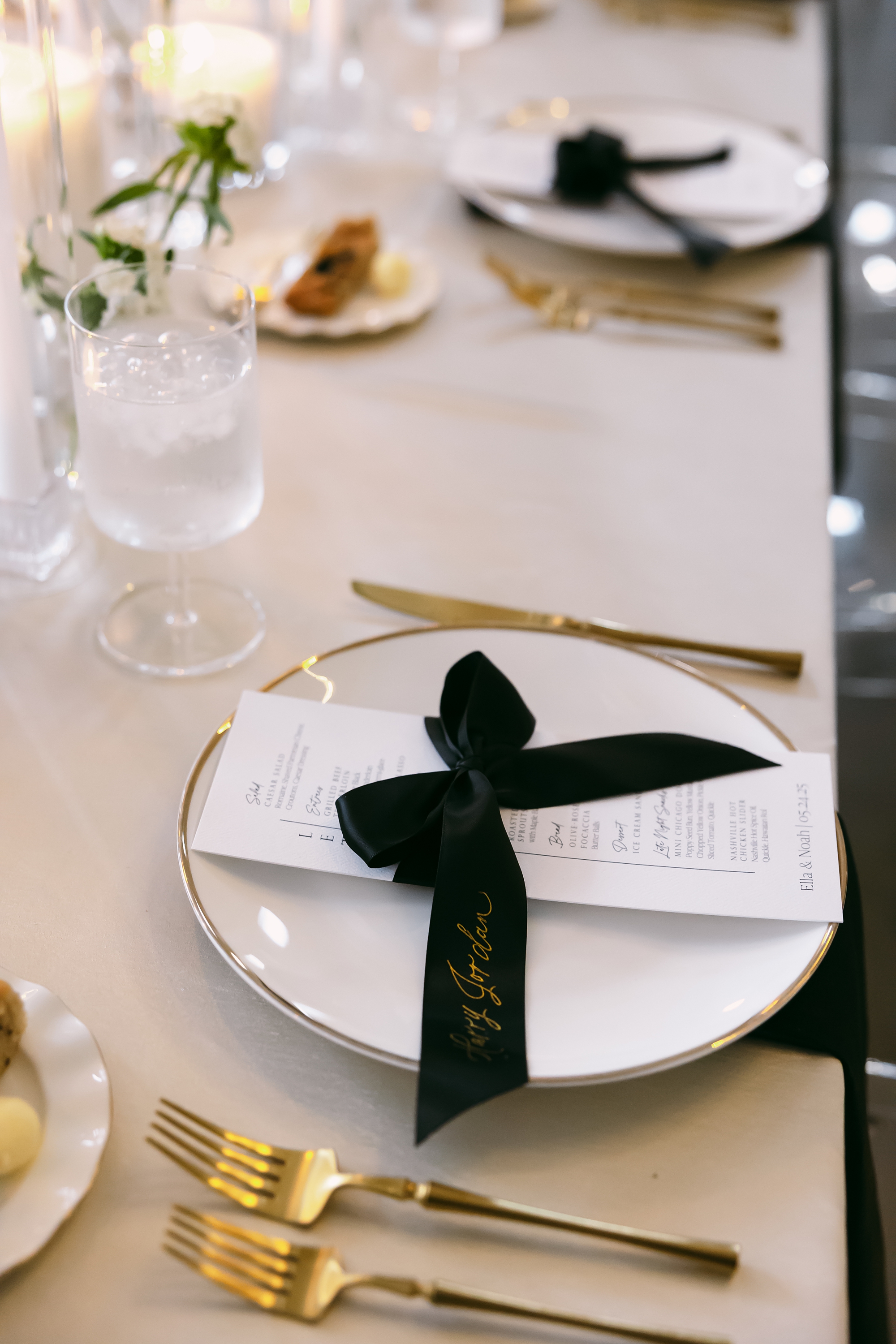 black satin ribbon place cards tied around white menus at place setting from Nashville Wedding