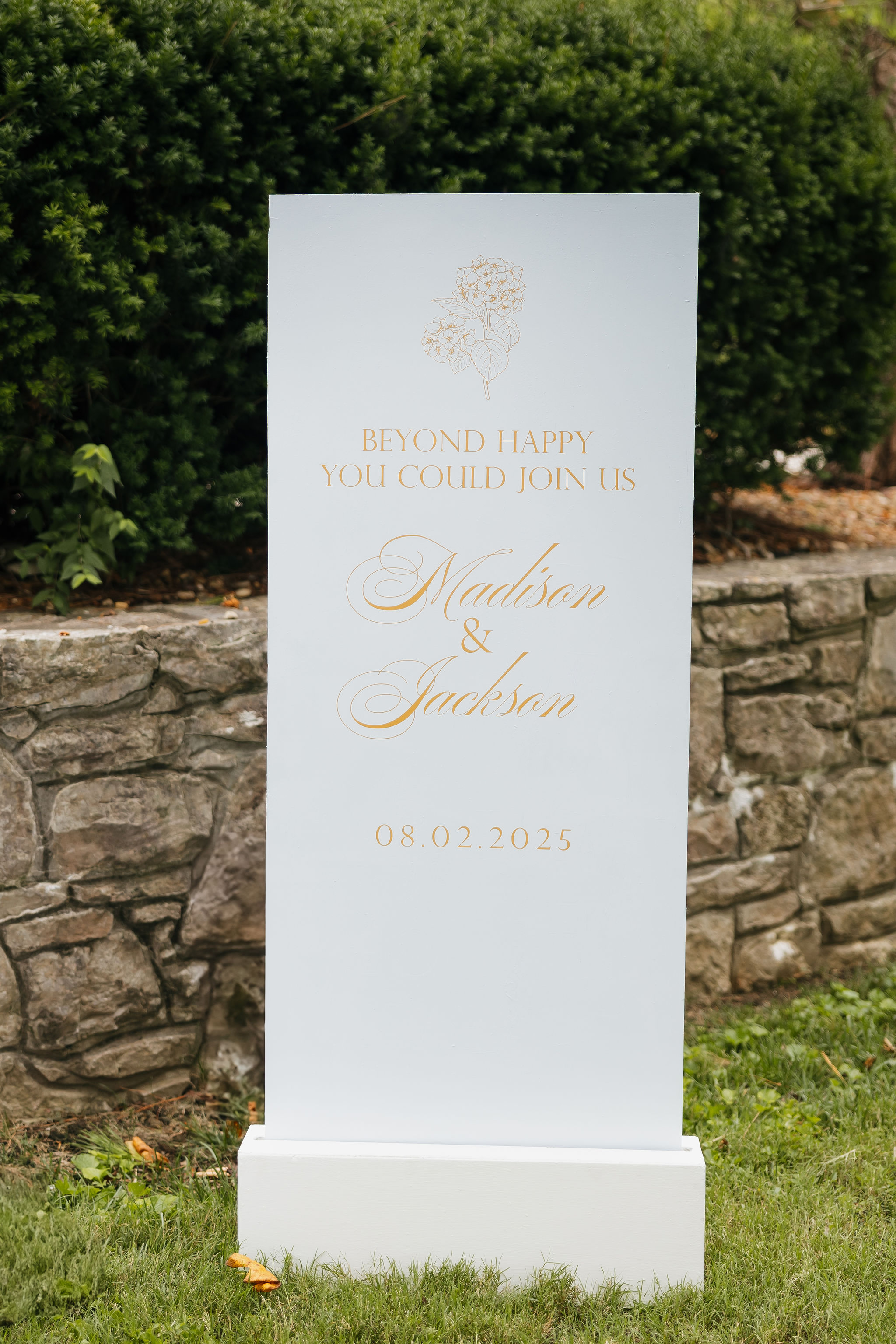 white wedding welcome sign with light orange lettering 