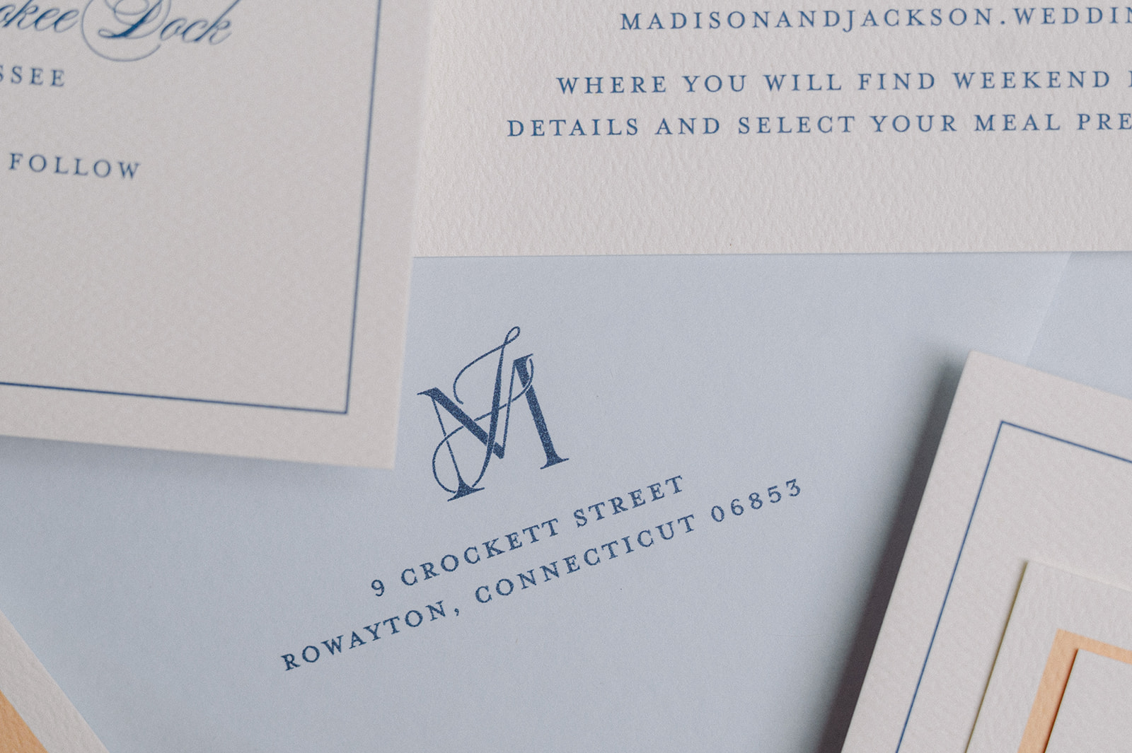 invitation suite with monogram on light blue envelope
