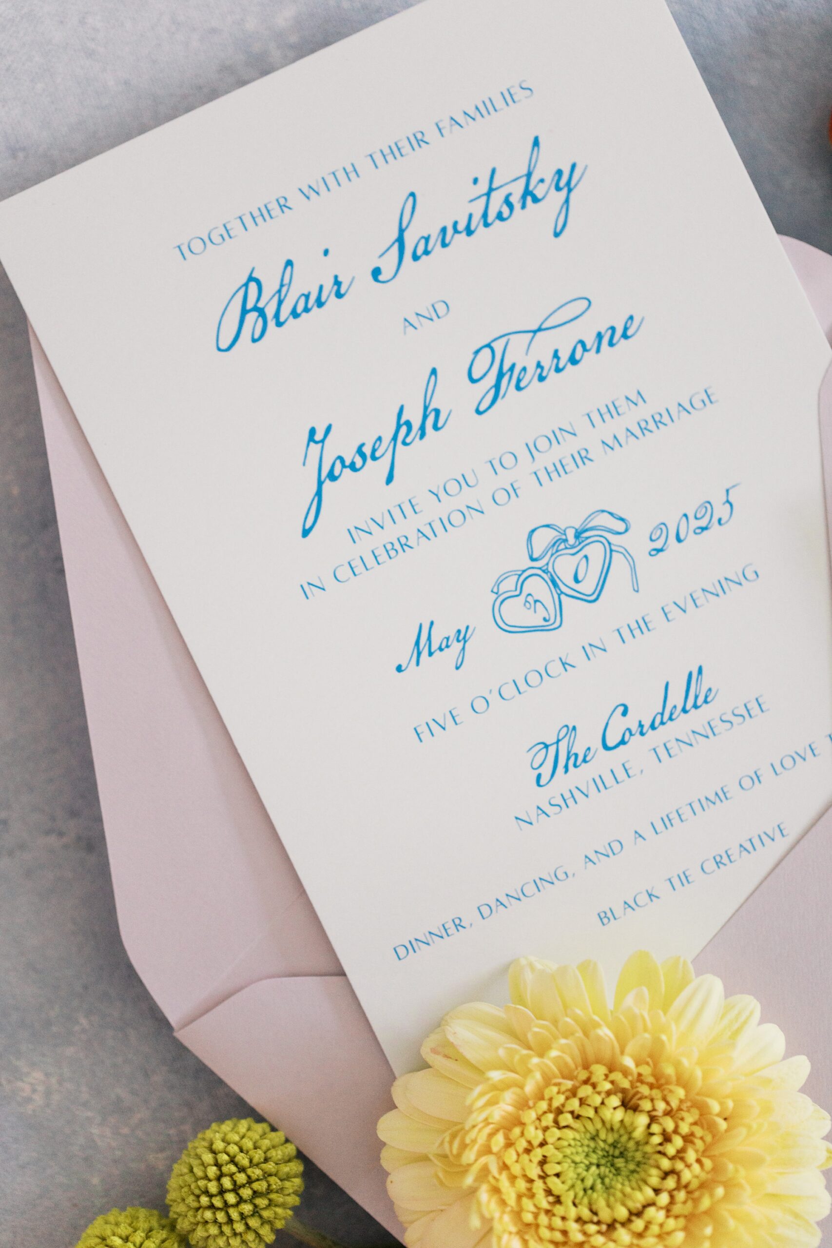 white invitations with blue calligraphy 