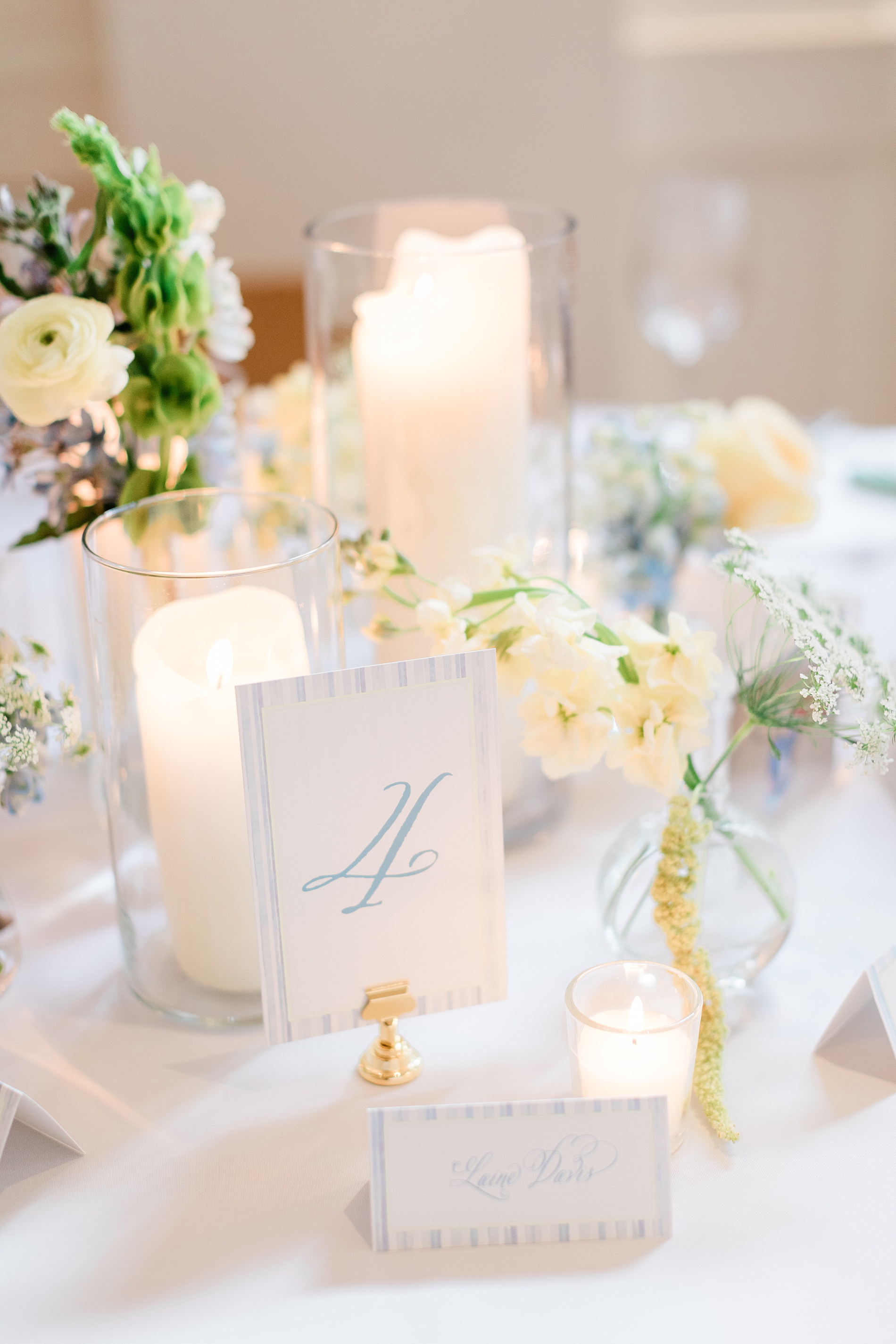 table numbers in light blue and place cards with matching border 