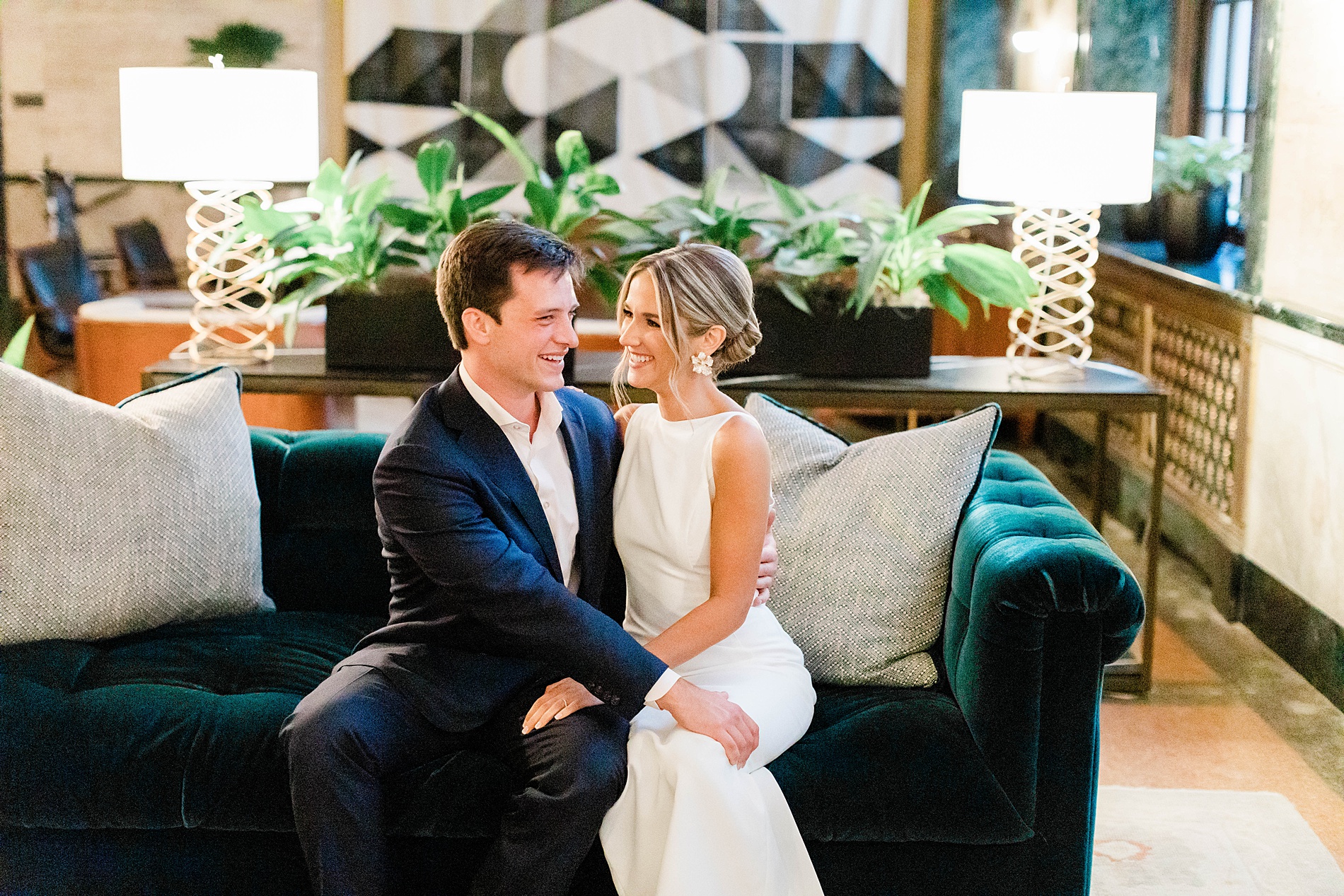 soon-to-be-newlyweds sit on couch at rehearsal dinner 