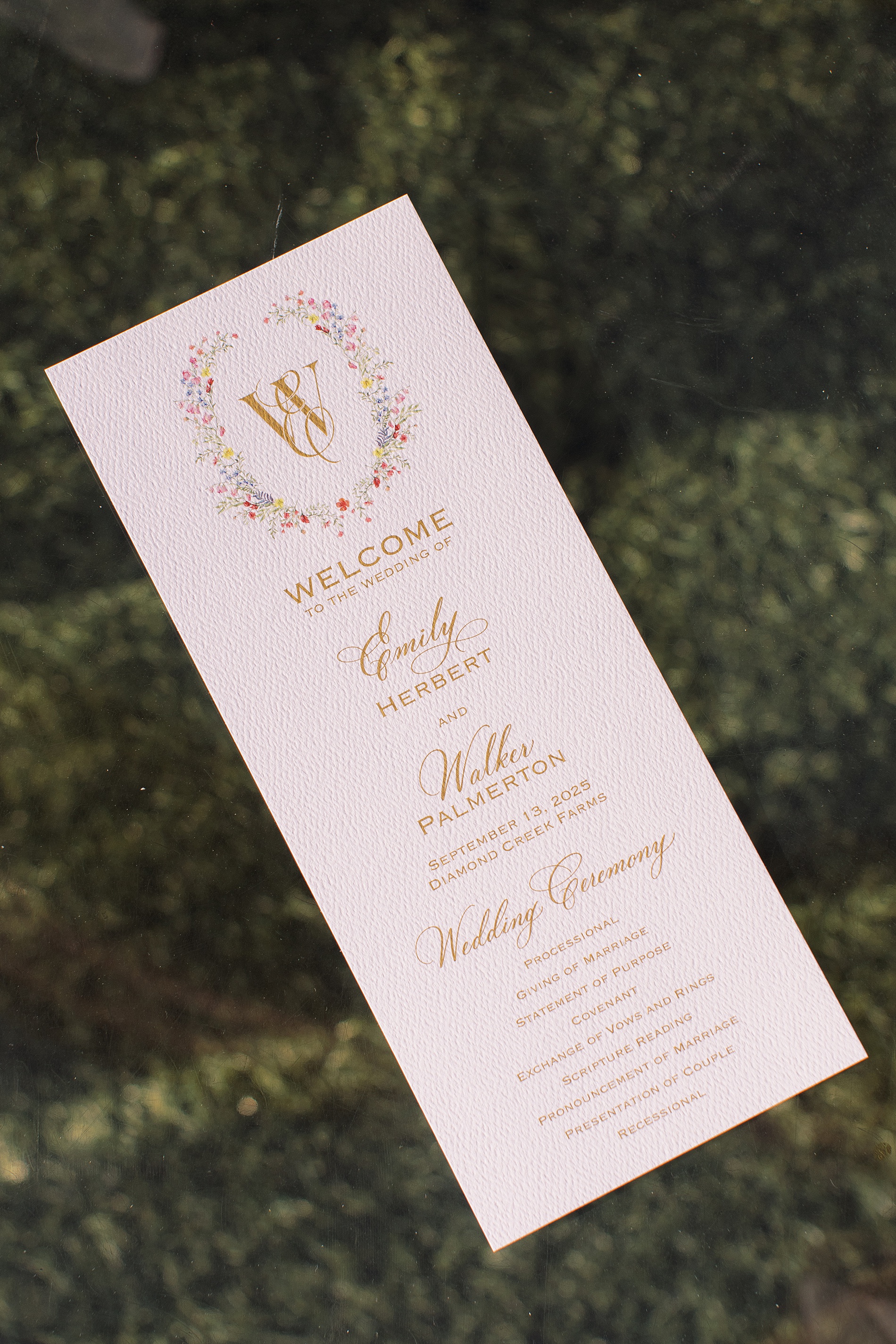 wedding programs featuring floral artwork and monogram created by Nashville Full-service wedding design house