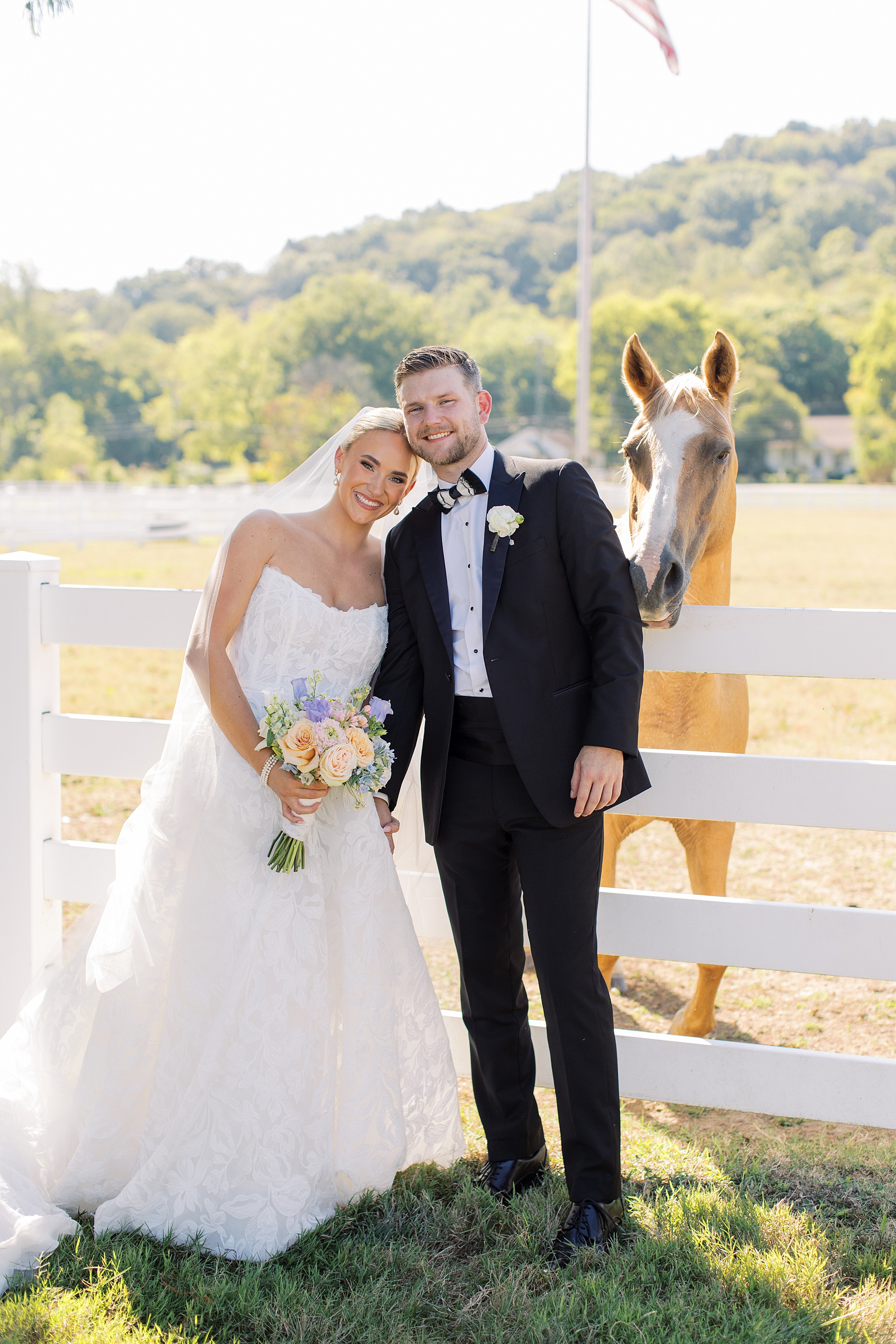 newlyweds by horse at Diamond Creek Farms wedding 