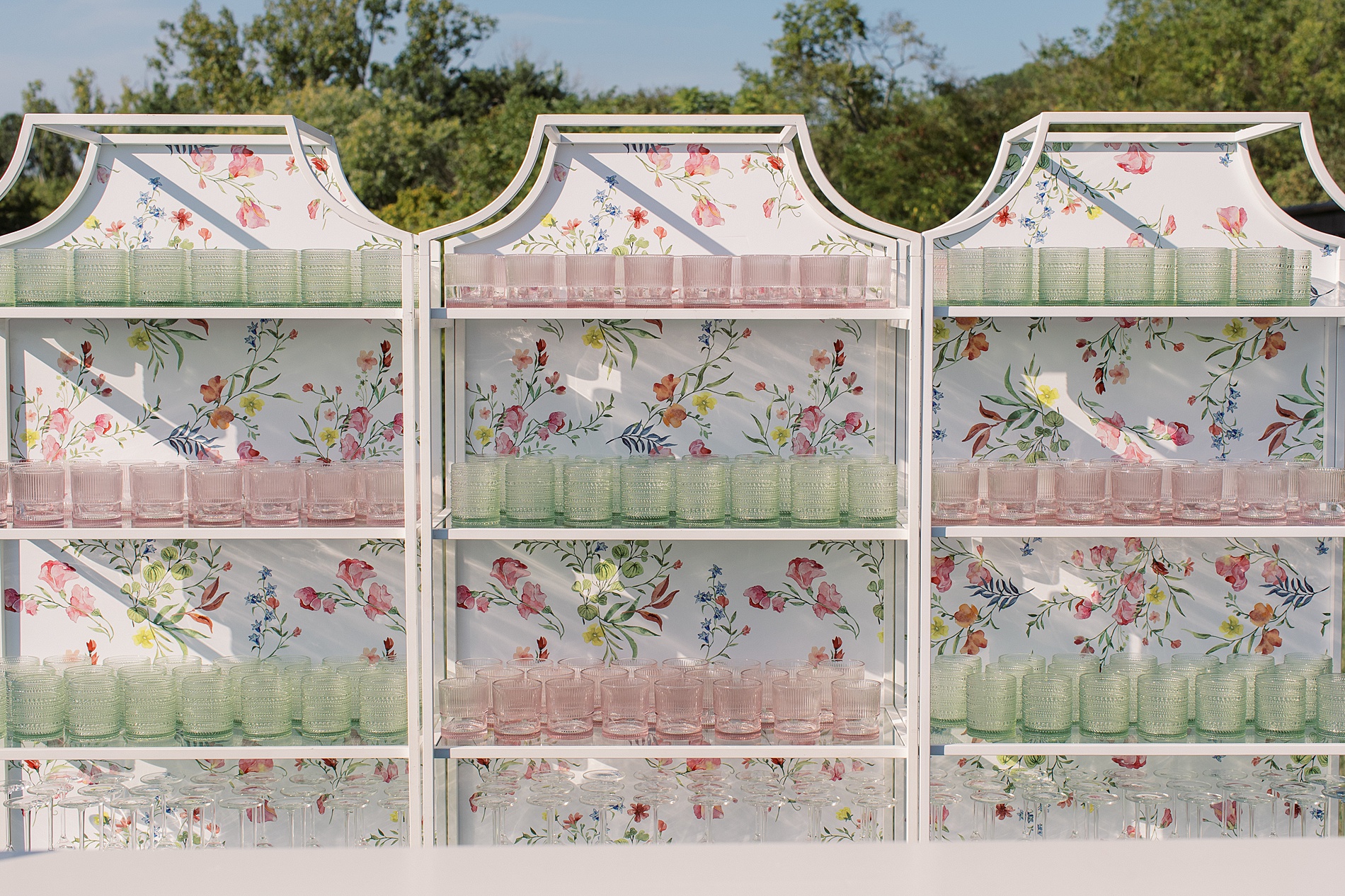 Custom floral artwork on bar back at cocktail hour