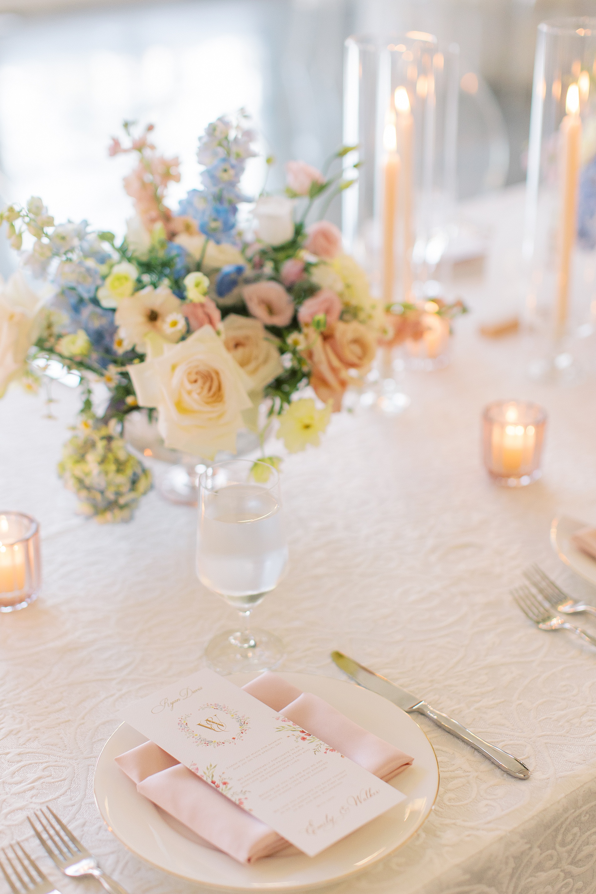 Custom floral artwork from envelope liners on wedding menus at reception