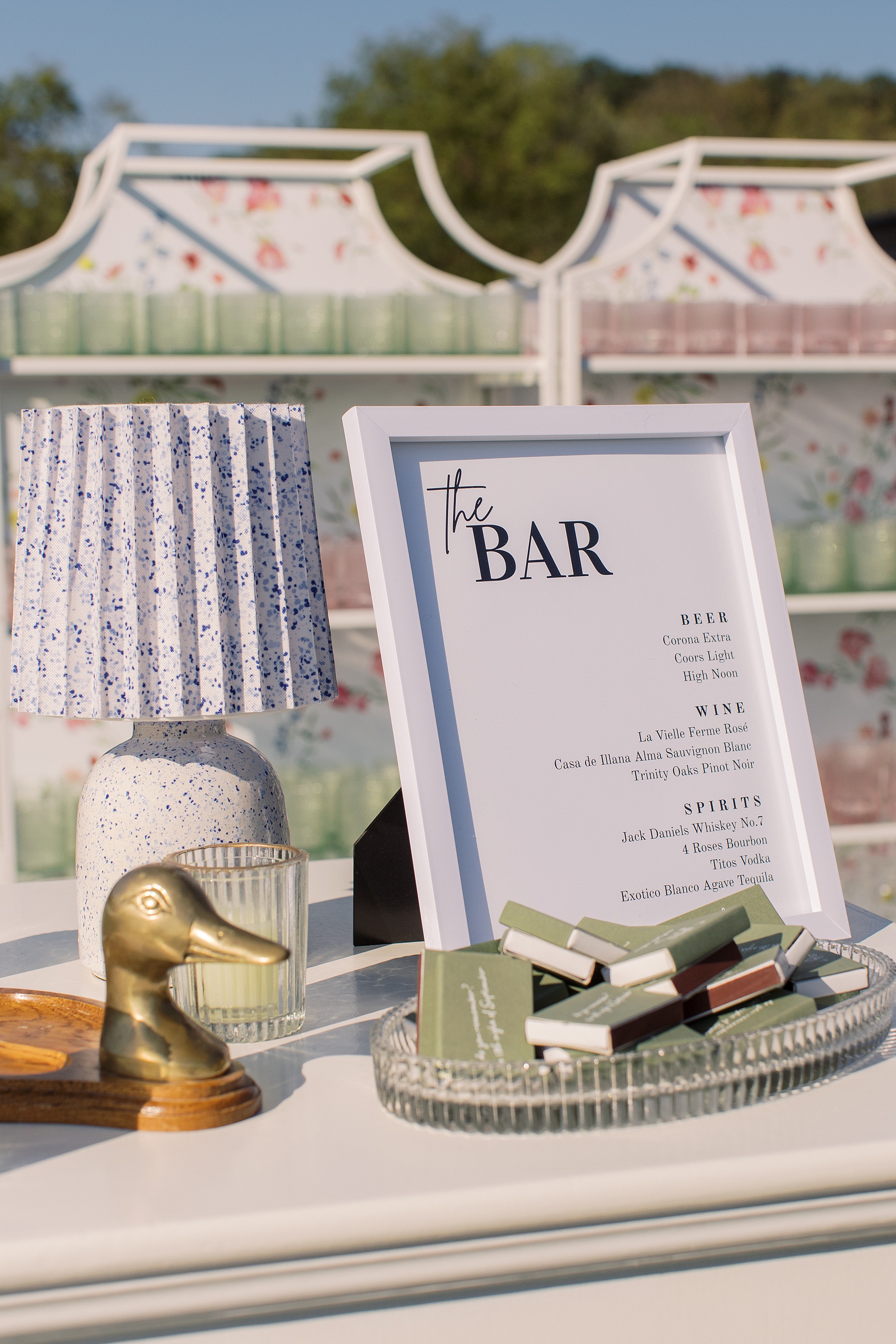 Custom floral artwork on bar back at cocktail hour