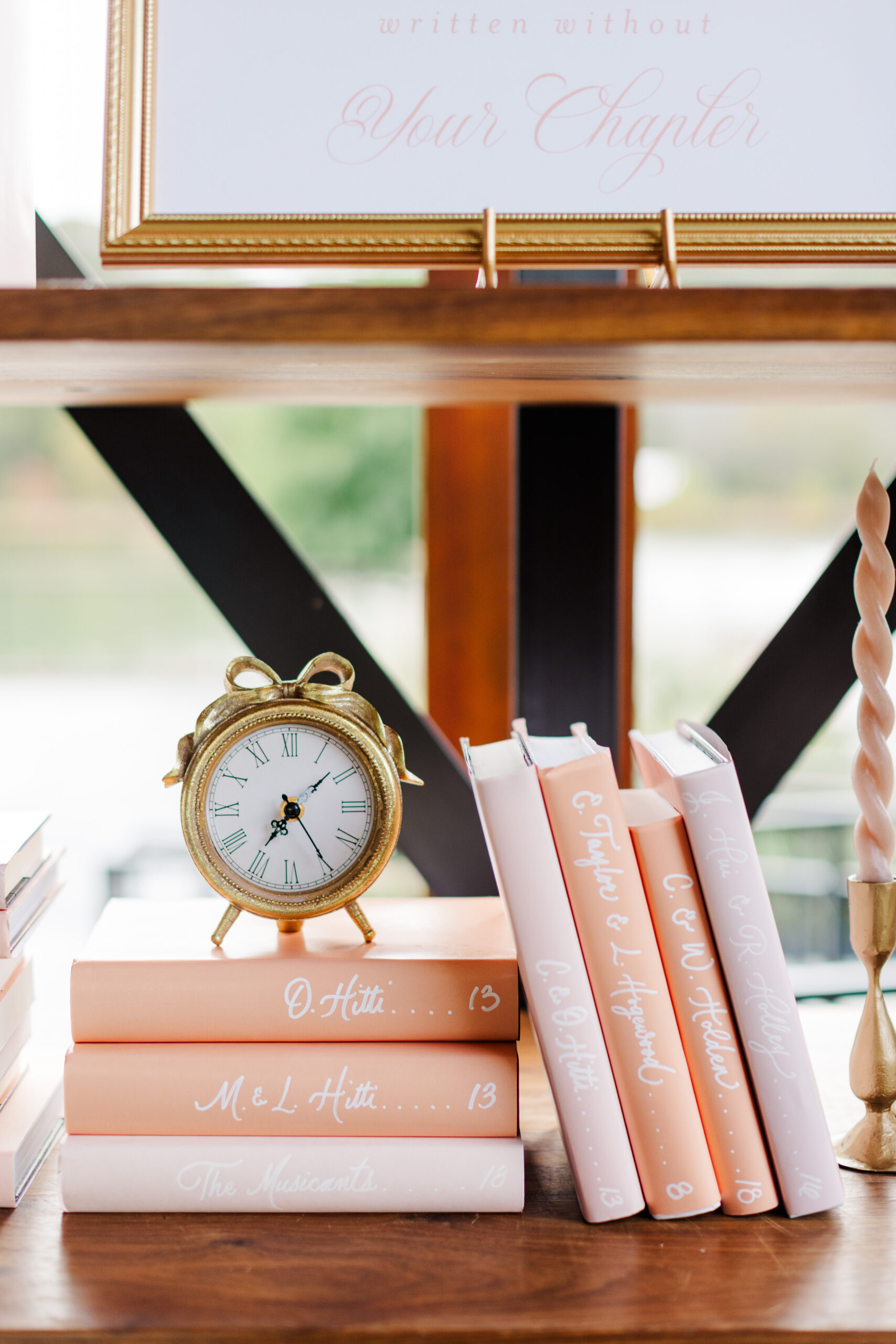 pink and orange book spines on shelf for book seating chart