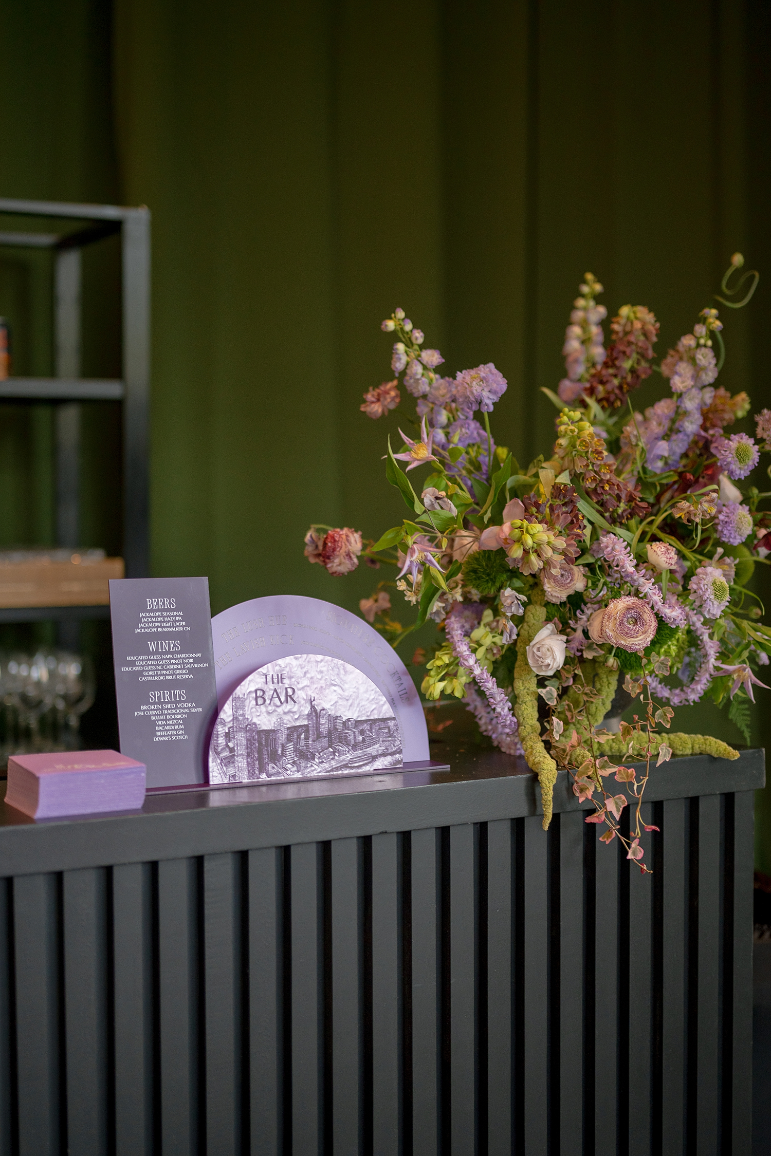 bar signs and cocktail napkins sit on bar top created by Nashville full- service event design house 
