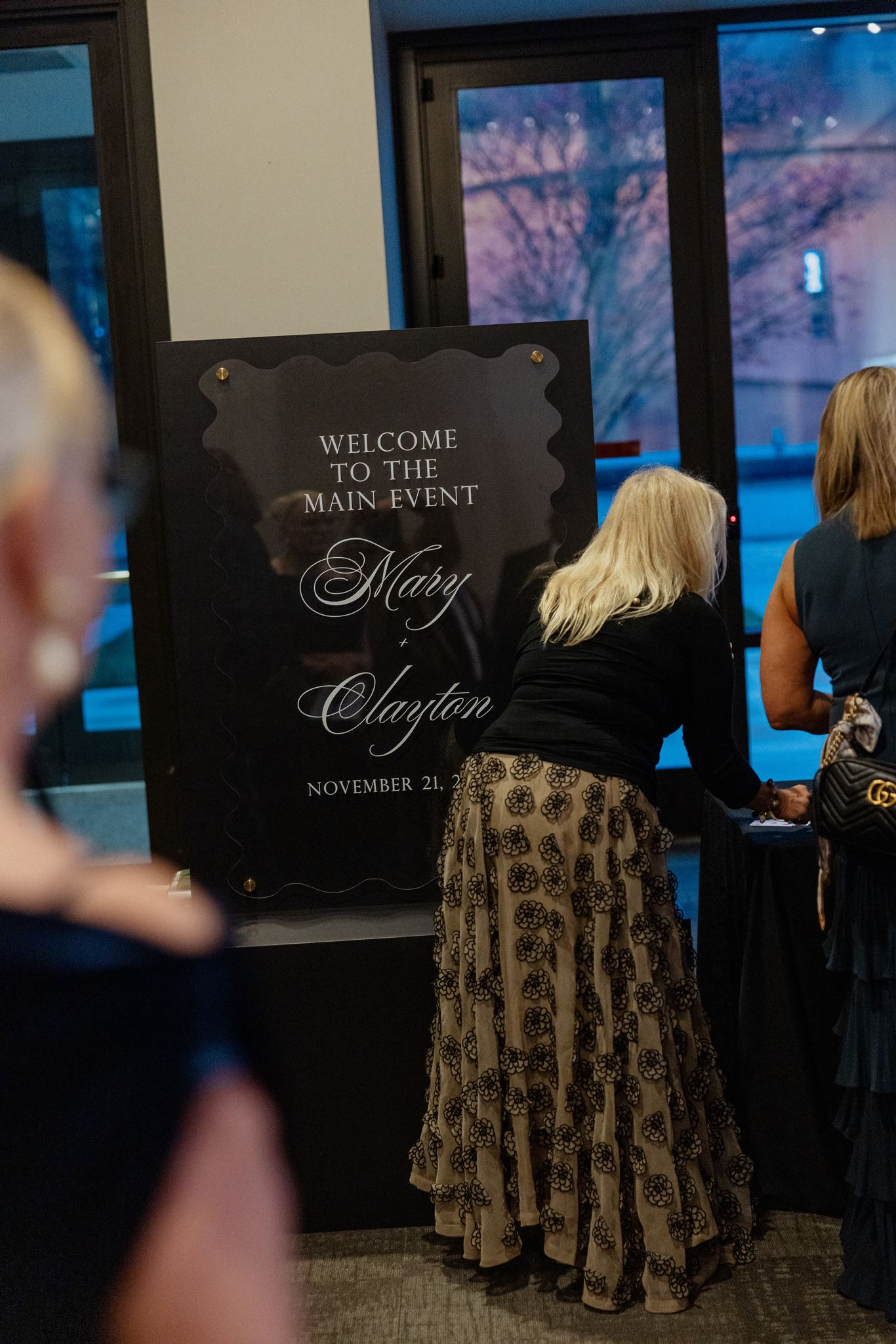 black wedding welcome sign with clear acrylic cut in wavy design to match wedding menus 