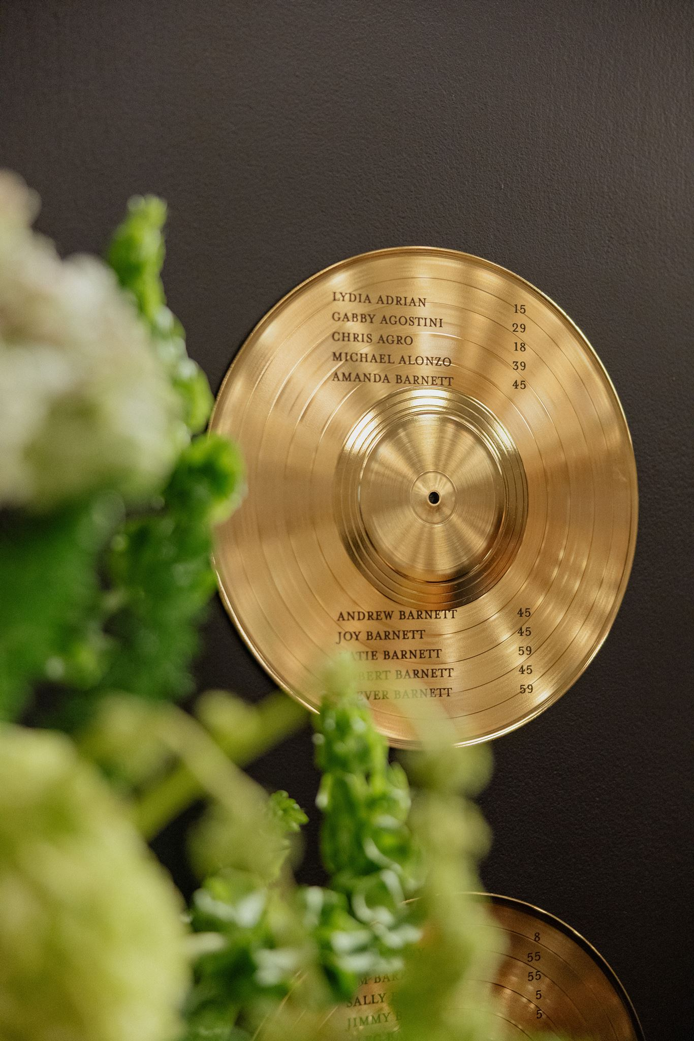 gold vinyl record displaying seating assignments at Music City wedding at Country Music Hall of Fame  created by Nashville wedding design house, White Ink Calligraphy 
