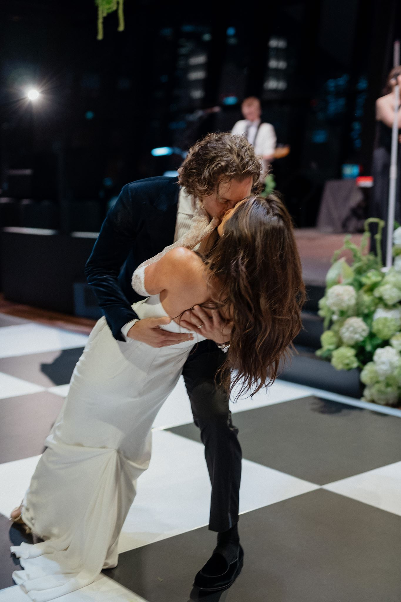 bride and groom kiss on dance floor