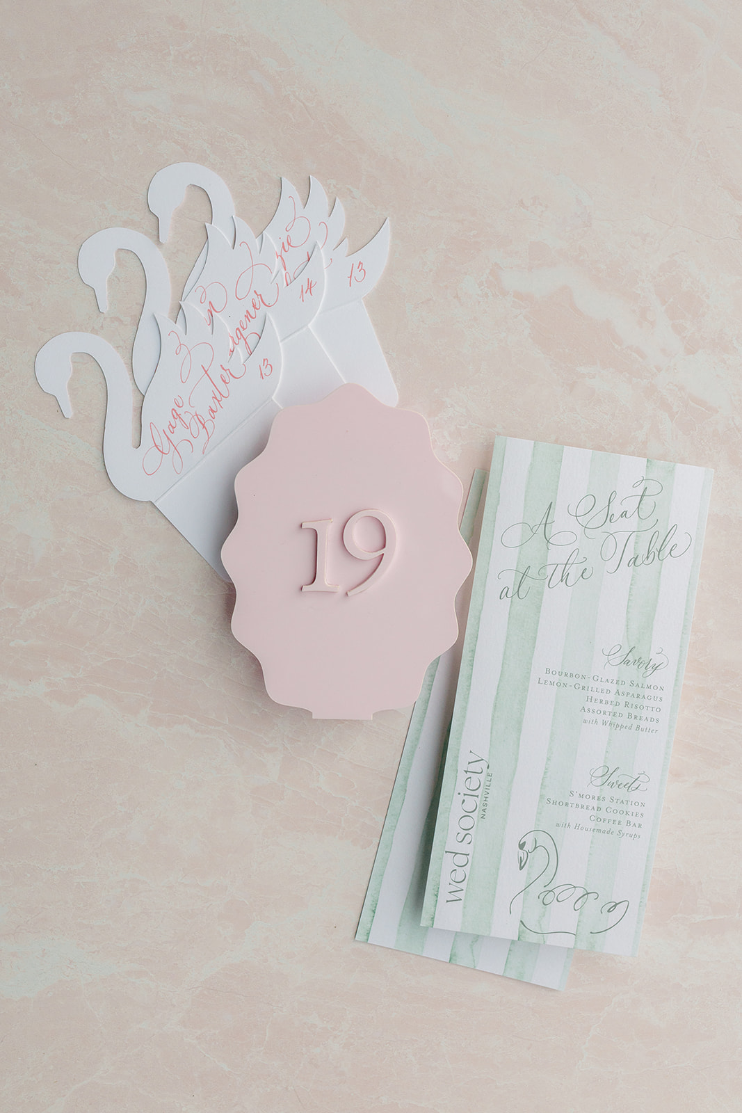 swan escort cards, soft pink table numbers and custom menus with swan sketch | day of event details created by White Ink Calligraphy