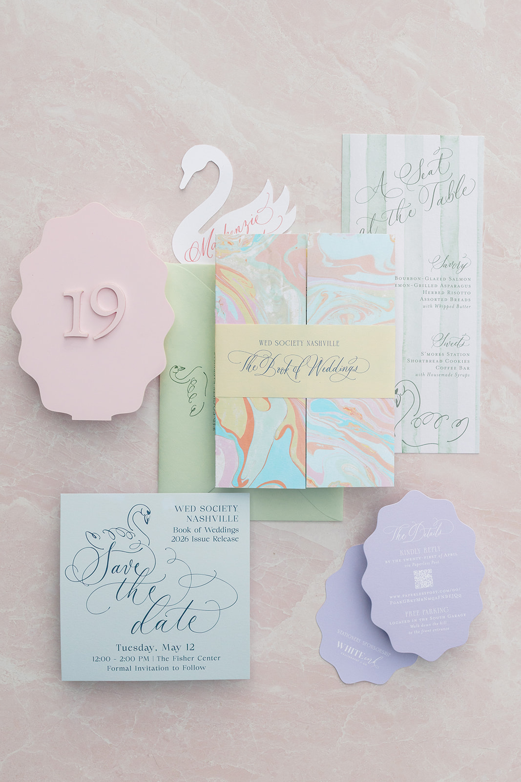 Event invitation suite with soft pastel colors and marble artwork on gatefold invitation