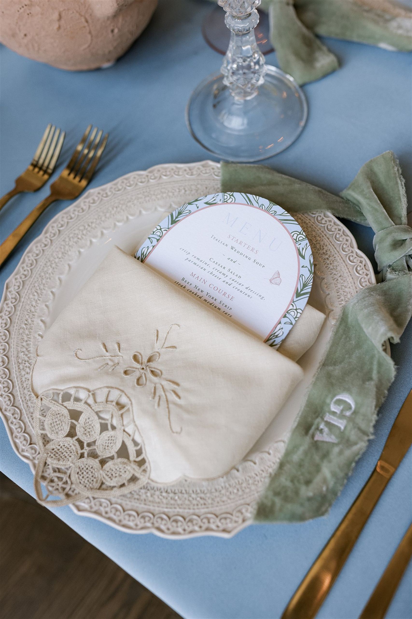oval shaped menu with decorative border tucked into napkin 