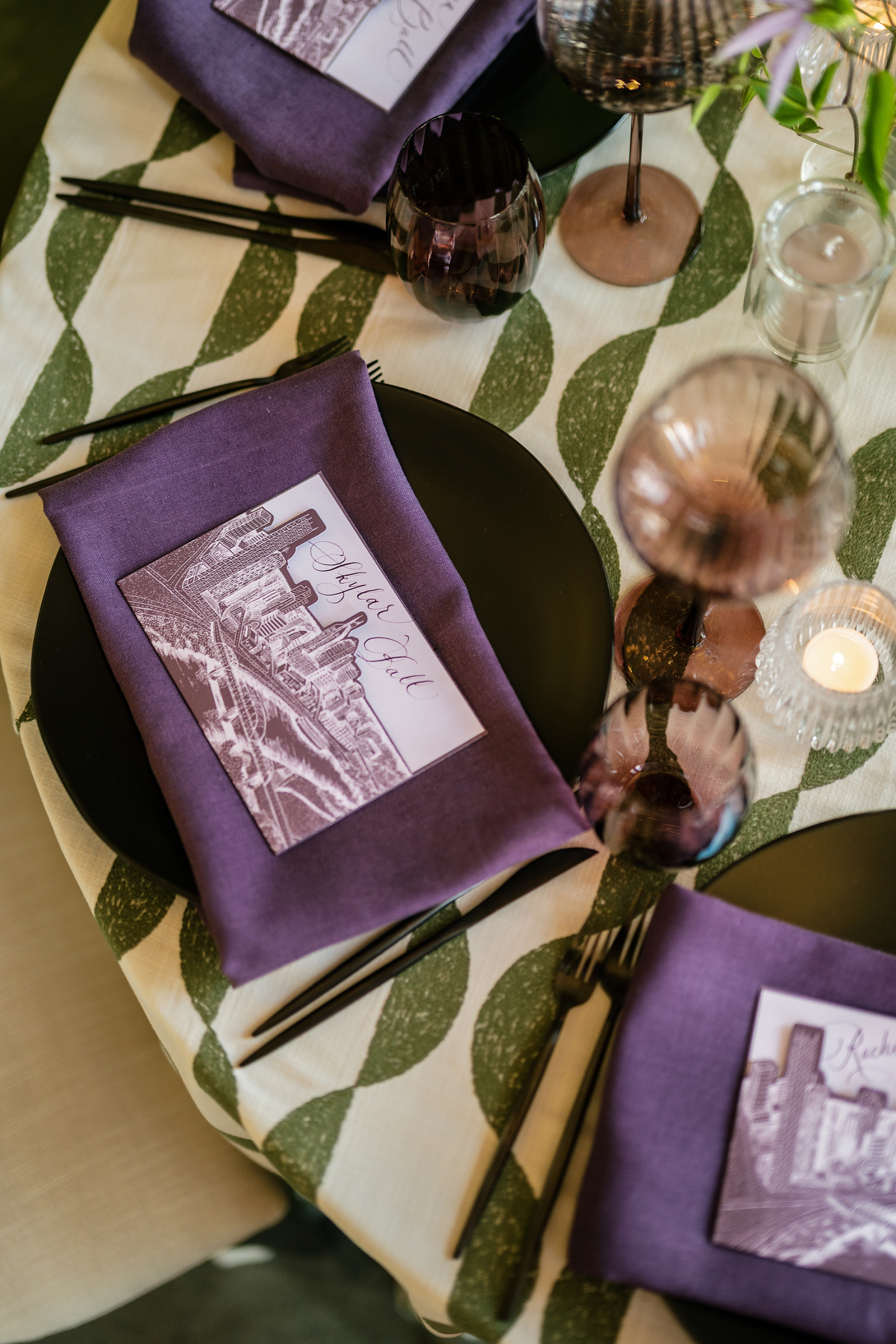 Custom purple menu tucked into pocket with sketch of Nashville cityscape