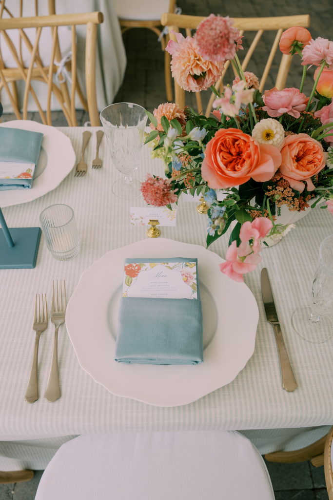 custom menus tucked in napkin and place cards in gold base