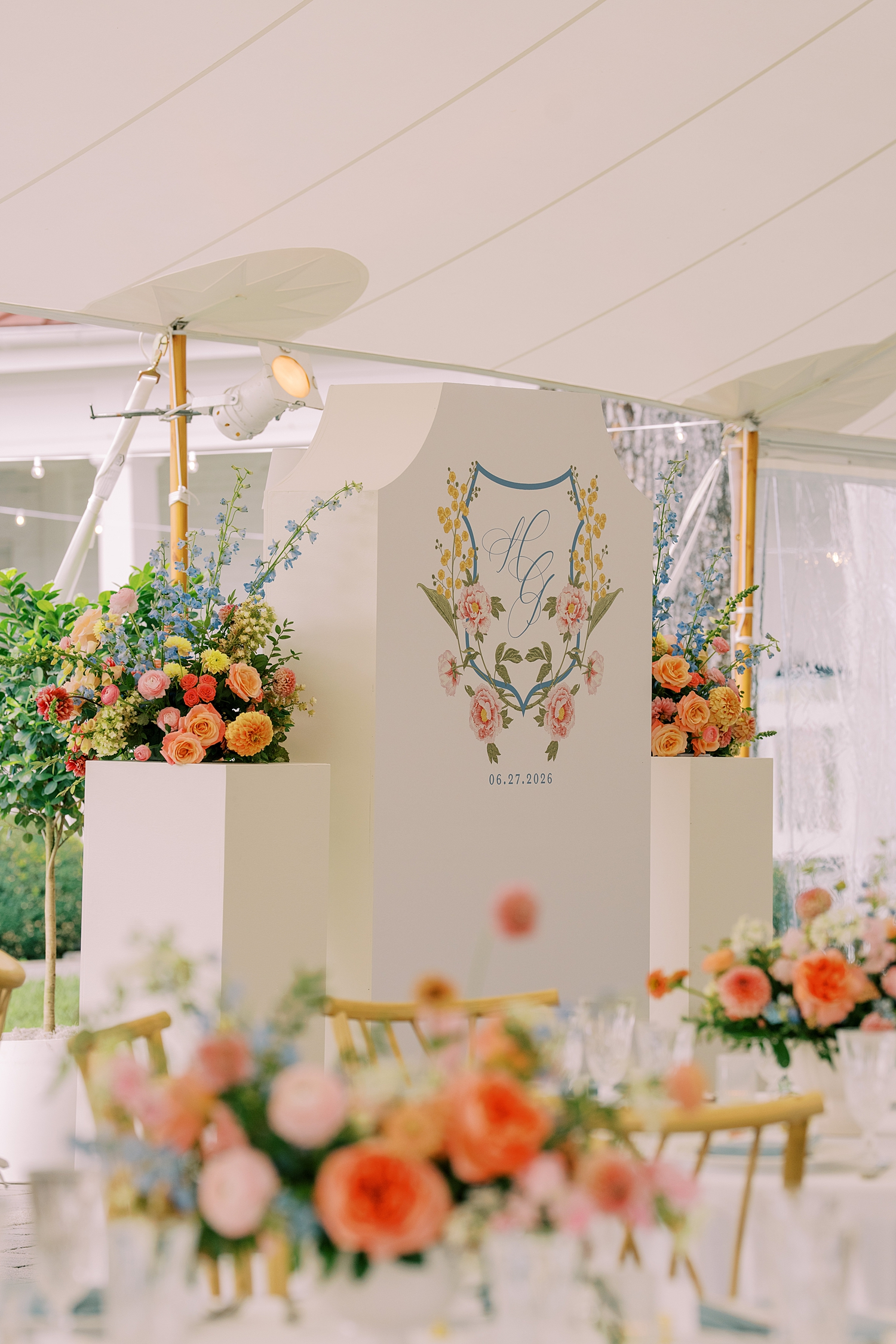couple's custom crest and monogram on back of seating chart facing reception area designed by White Ink Calligraphy + Co.