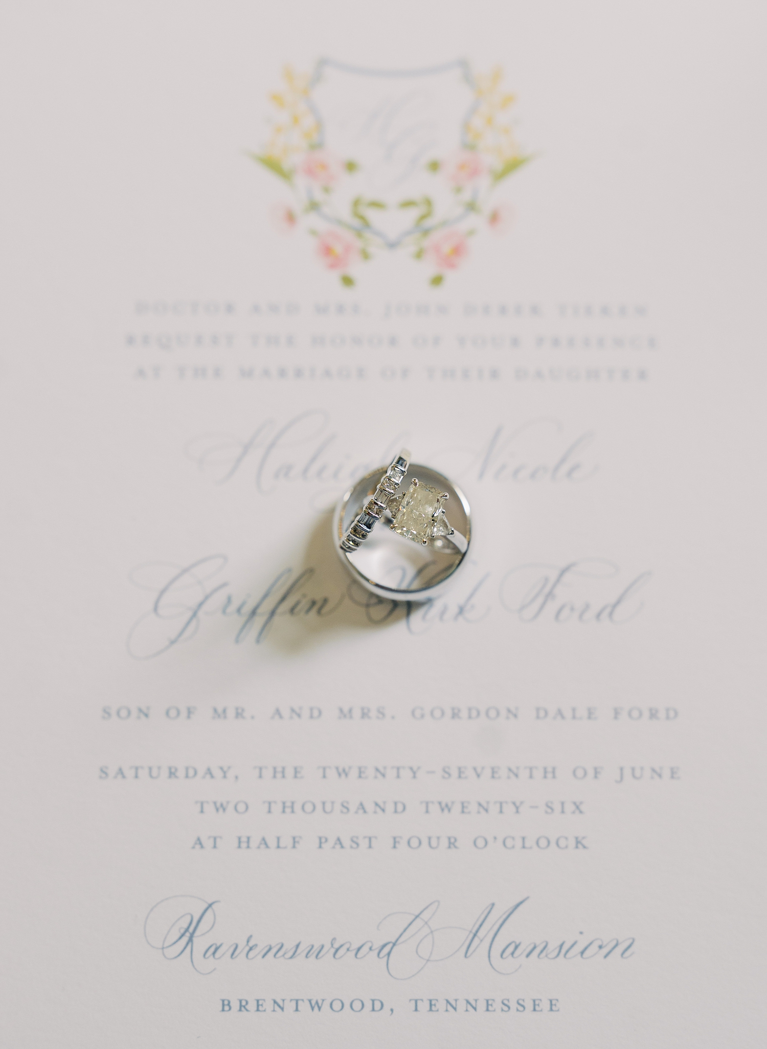 wedding invitation with couple's crest and monogram