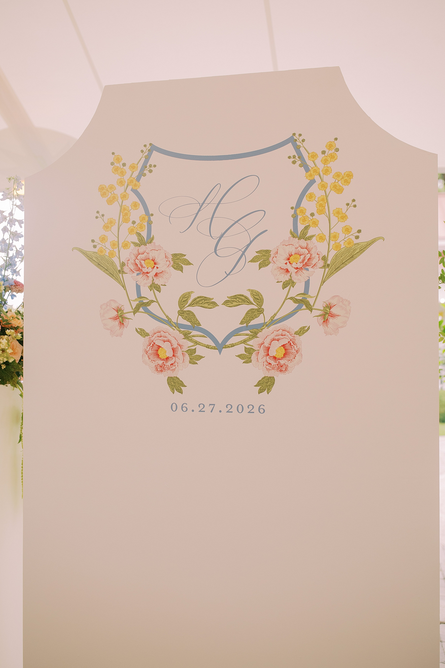 couple's custom crest and monogram on back of seating chart facing reception area designed by White Ink Calligraphy + Co.